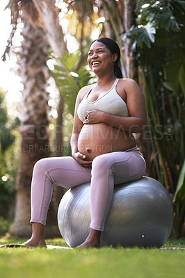 Buy stock photo Shot of a pregnant woman sitting on a stability ball outside