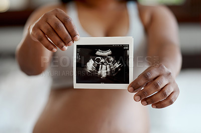 Buy stock photo Closeup shot of an unrecognisable woman holding a sonogram at home