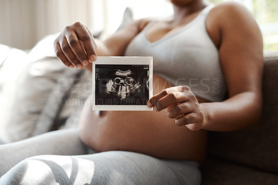 Buy stock photo Closeup shot of an unrecognisable woman holding a sonogram at home