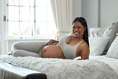 Buy stock photo Portrait of a pregnant woman lying on a bed at home