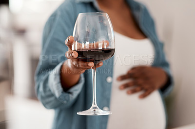 Buy stock photo Closeup shot of a pregnant woman holding a glass of red wine at home