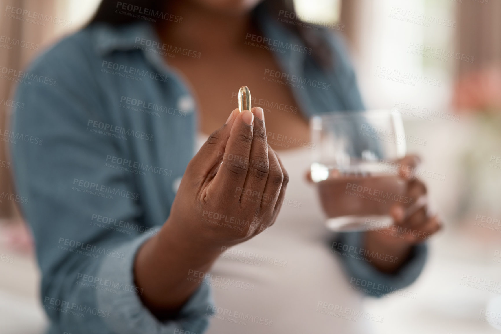 Buy stock photo Closeup shot of a pregnant woman taking medication at home