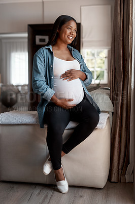 Buy stock photo Shot of a pregnant woman looking thoughtful at home
