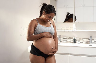 Buy stock photo Shot of a pregnant woman in the bathroom at home