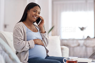 Buy stock photo Shot of a pregnant woman talking on her cellphone while sitting on the sofa at home