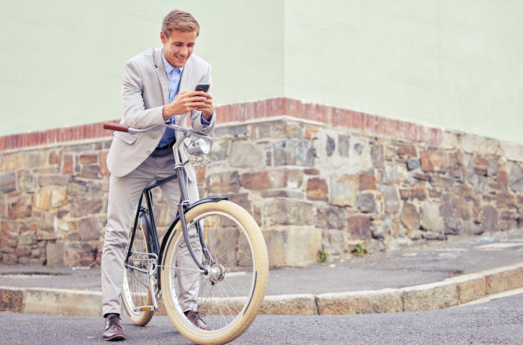 Buy stock photo Businessman, bike and phone on street for internet, reading text and commute. Employee, bicycle and mobile app by sidewalk with sustainable transport for work travel, web connection and social media