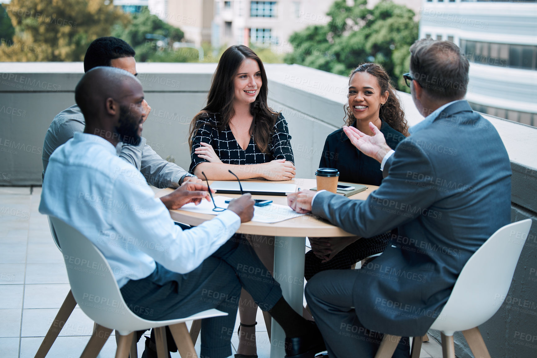 Buy stock photo Businesspeople, meeting and outside with smile at table on rooftop for brainstorming or collaboration. Teamwork, about us and planning for career with conversation with colleagues in town in London. 