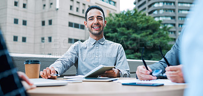 Buy stock photo Portrait of a young businessman having a meeting with his colleagues on the balcony of an office