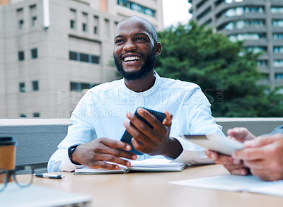 Buy stock photo Shot of a young businessman using a cellphone during a meeting on the balcony of an office