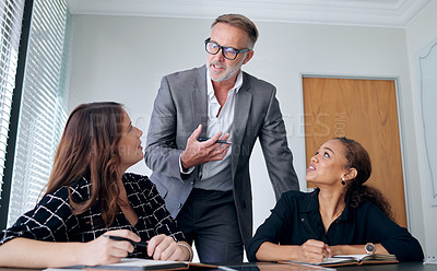 Buy stock photo Mature businessman, team and meeting in office with employees, leader and expertise in industry. Male boss, ideas and women together for learning, coaching and mission in corporate workplace