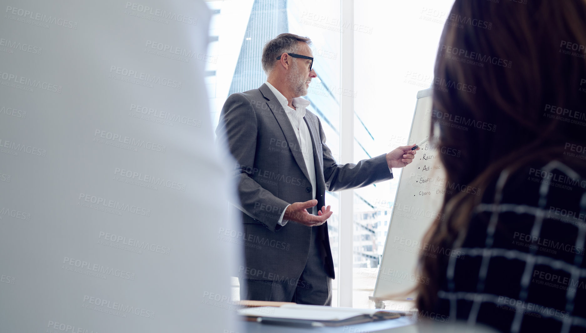Buy stock photo Shot of a mature businessman
delivering a presentation in the boardroom of a modern office