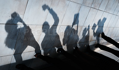 Buy stock photo Shot of shadows of people using various devices