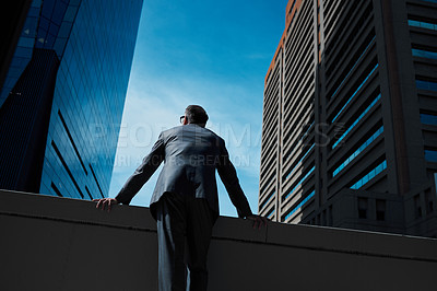 Buy stock photo Business, man and thinking at city on rooftop about career or future with goal in company. Professional, person and skyscraper on roof is standing with vision or hope for decision as leader at work.