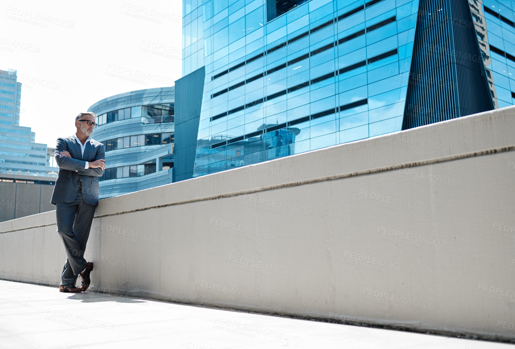 Buy stock photo Outdoor, wall and businessman in city thinking of development in property or real estate mockup. Realtor, entrepreneur and man with arms crossed at office building with idea, opportunity or progress