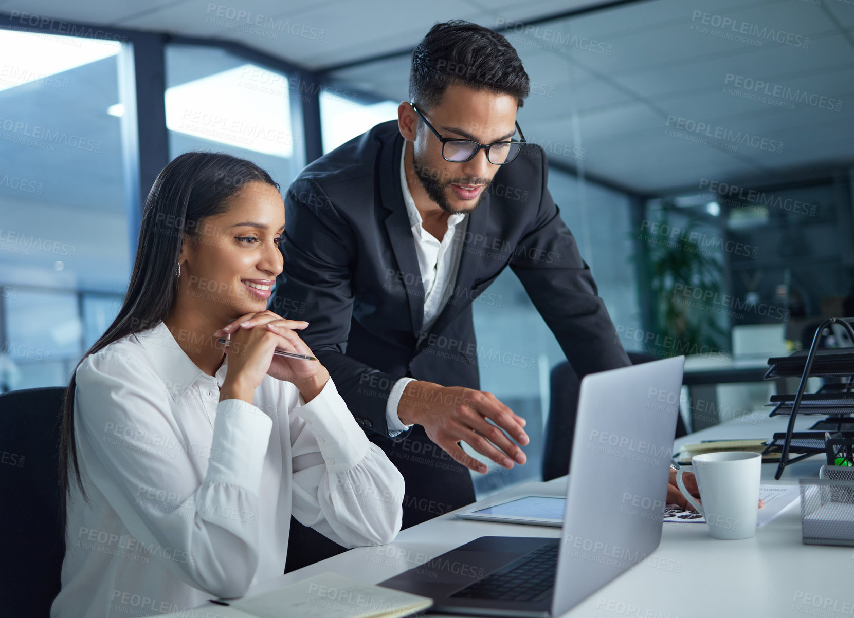 Buy stock photo Shot of two work colleagues working together during a meeting