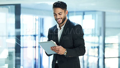 Buy stock photo Shot of a young businessman using a digital tablet