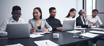Buy stock photo Shot of a group of businesspeople working together in the boardroom