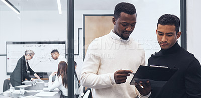 Buy stock photo Shot of a male businessman signing paperwork at the office