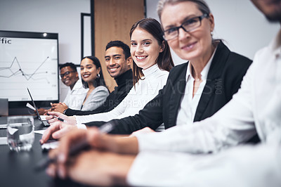 Buy stock photo Shot of a group of business people sitting together in their office