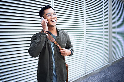 Buy stock photo Asian man, glasses and phone call outdoor with talking for virtual consultation, leather bag and conversation. Happy male person, discussion on mobile in city with contact, 5g network and good news