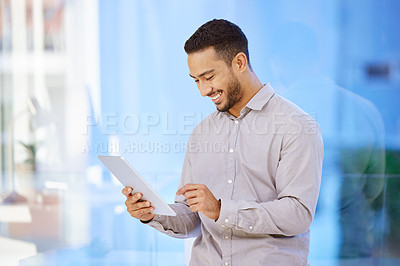 Buy stock photo Technology, man on a tablet and standing with smile in a office at his workplace. Social networking or connectivity, online communication, happiness and male person reading a email or report.