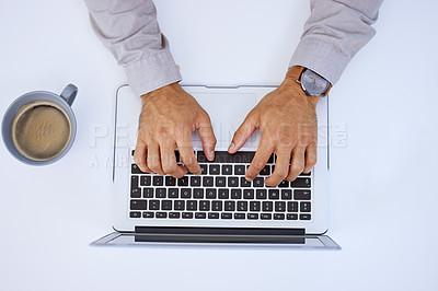 Buy stock photo Cropped shot of an unrecognizable businessman using his laptop while sitting at his desk