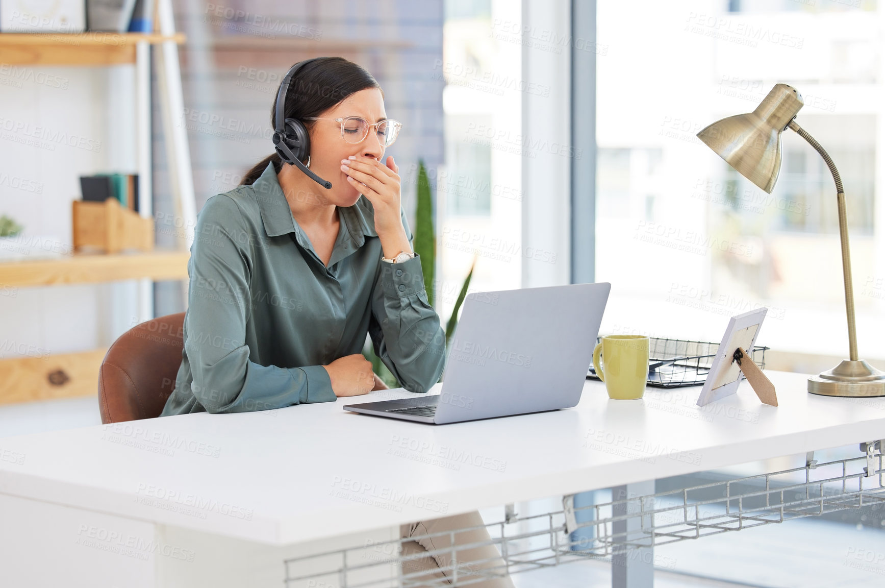 Buy stock photo Consultant, woman and tired in call center with laptop for customer support, internet glitch or yawning. Telemarketing, agent and exhausted with headset in office for brain fog, overworked or burnout