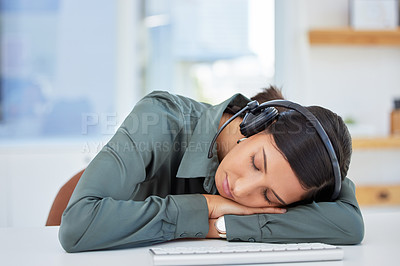 Buy stock photo Shot of an exhausted businesswoman taking a nap at her desk