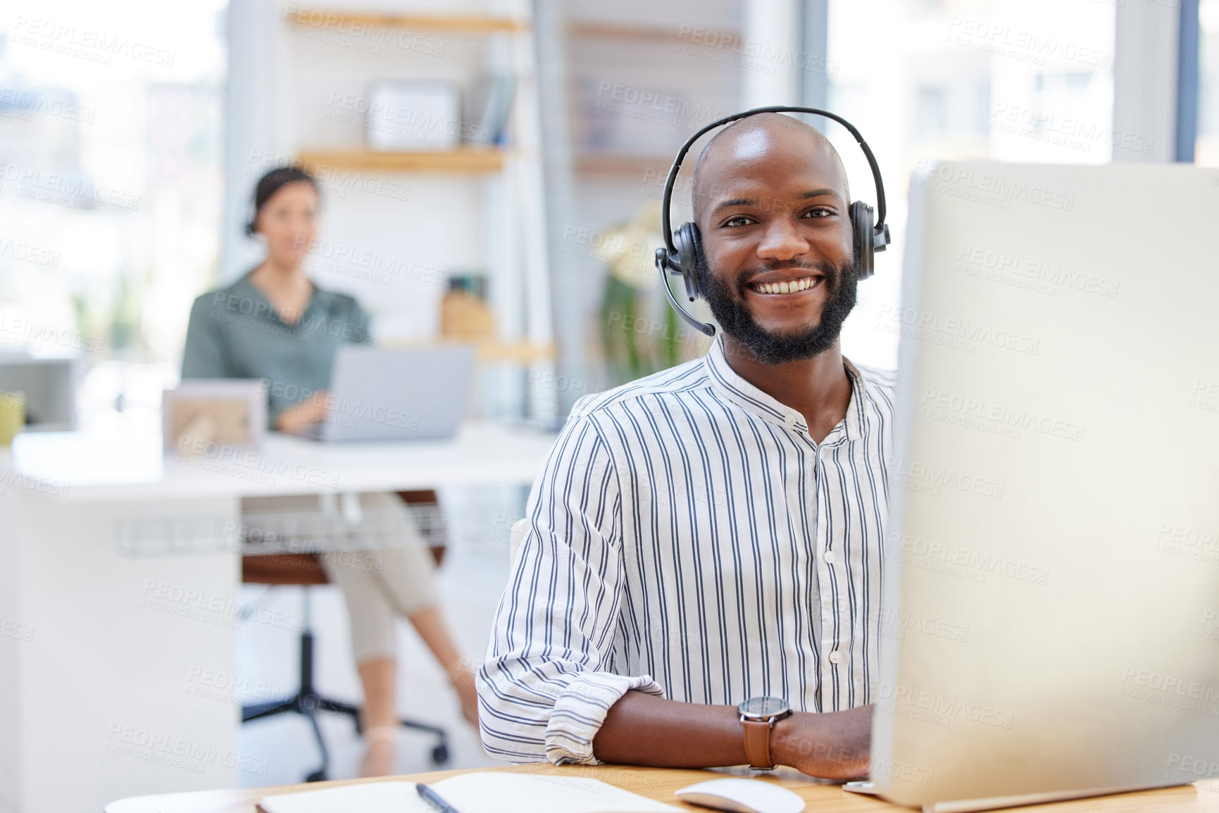 Buy stock photo Shot of a young businessman working in a call center