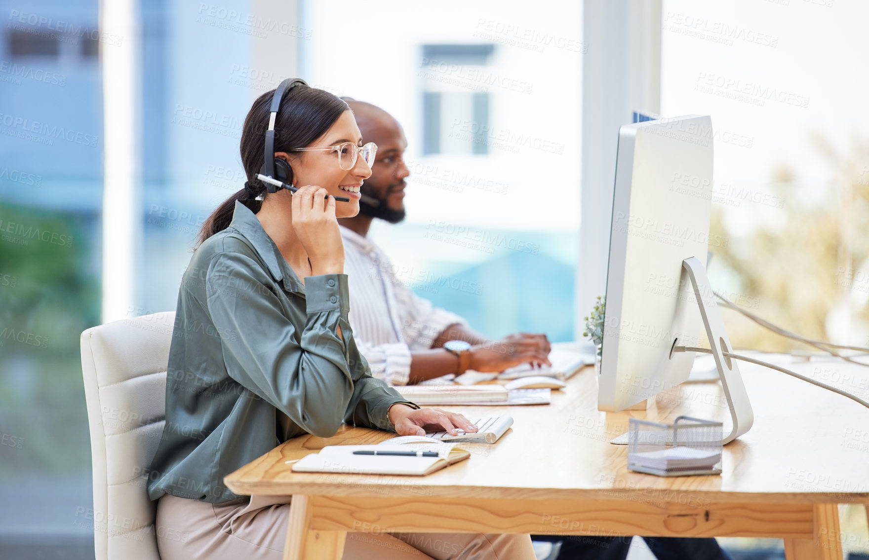 Buy stock photo Shot of two businesspeople working together in a call center