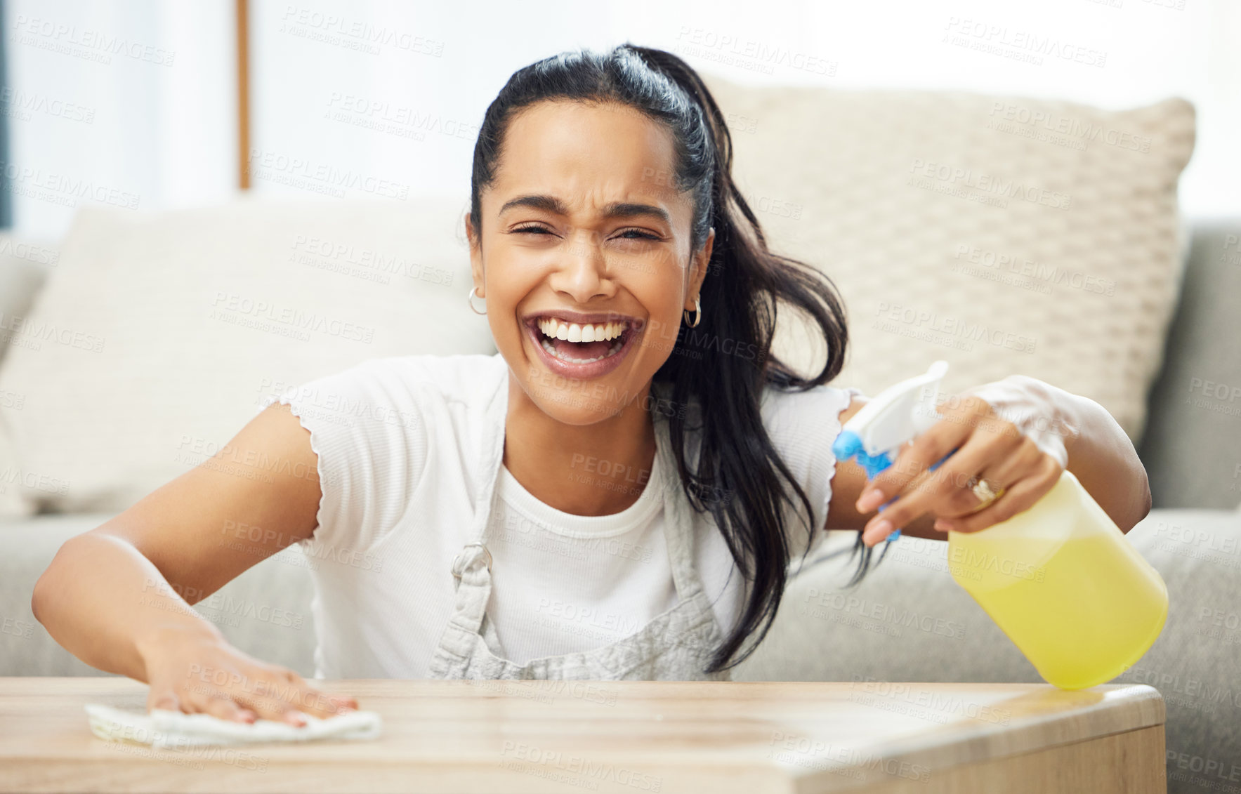 Buy stock photo Woman, spray and cloth for table in portrait for smile, laugh and domestic housework in living room. Girl, person or cleaner with bottle, chemical or liquid to shine wood in home for cleaning service