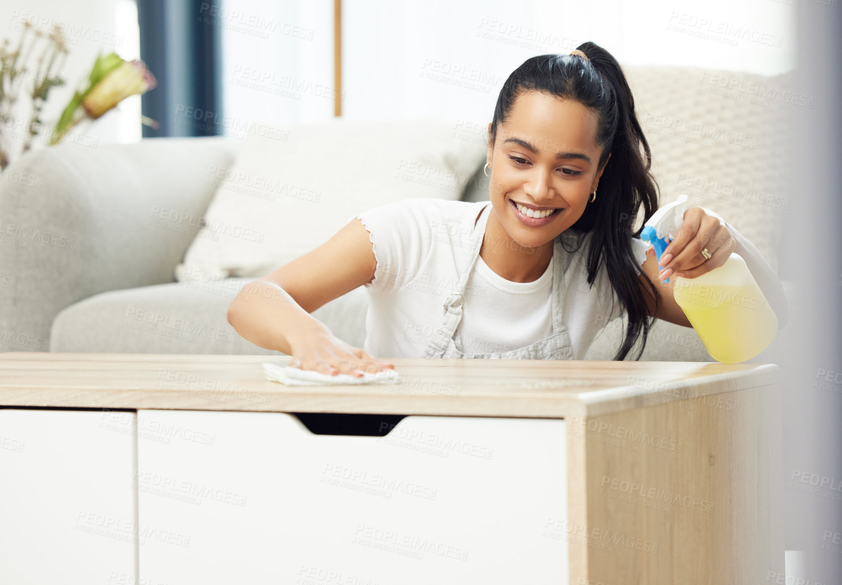 Buy stock photo Woman, spray and cloth on table with smile, thinking or domestic housework in living room. Girl, person or cleaner with bottle, chemical or liquid to shine wood in home for cleaning service in Mexico