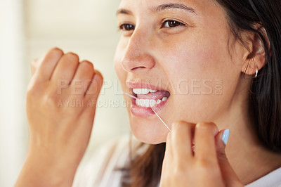 Buy stock photo Closeup shot of a woman flossing her teeth