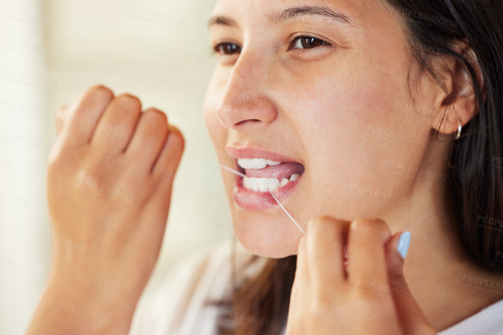 Buy stock photo Closeup shot of a woman flossing her teeth