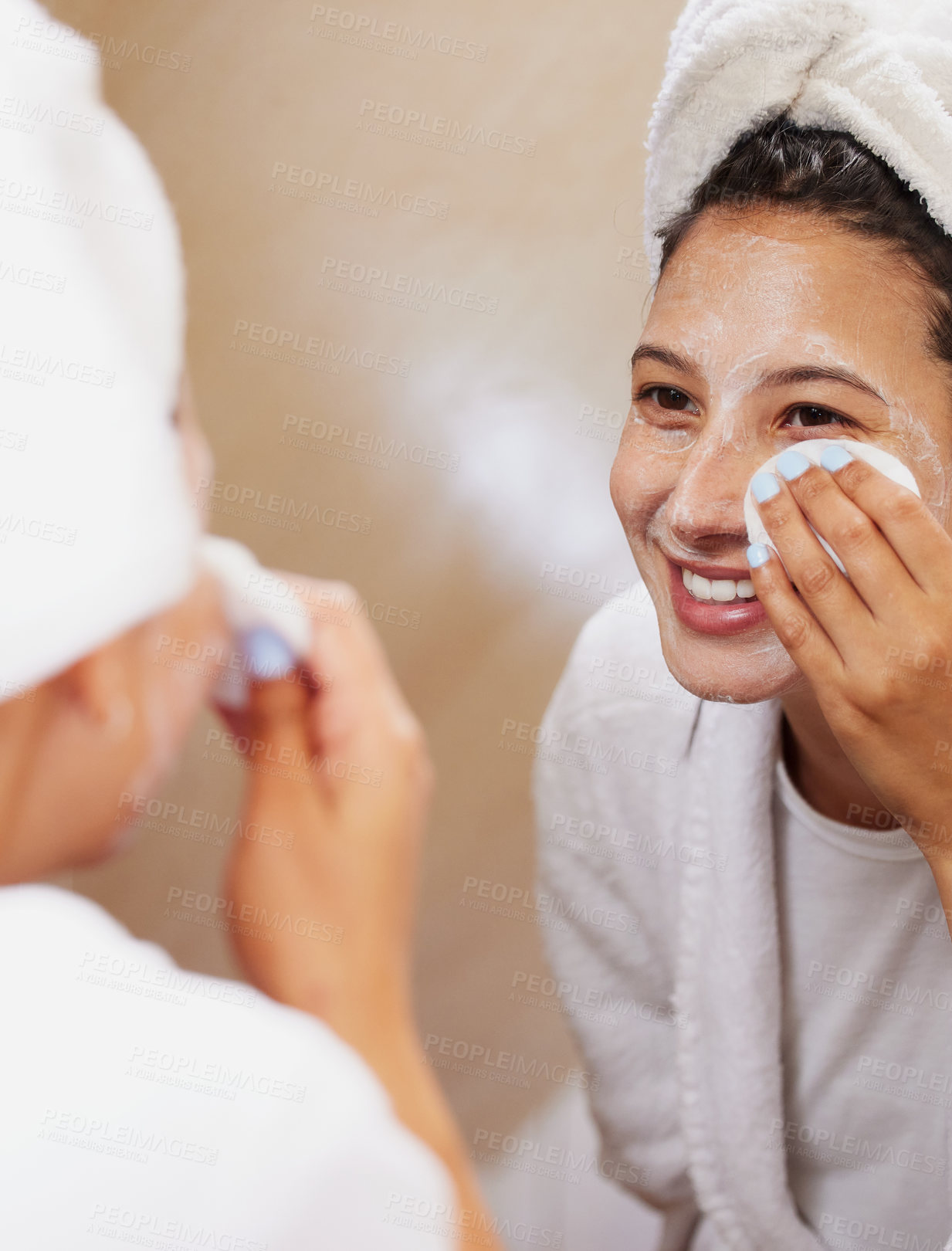 Buy stock photo Shot of a beautiful young woman looking in the mirror while cleaning her face