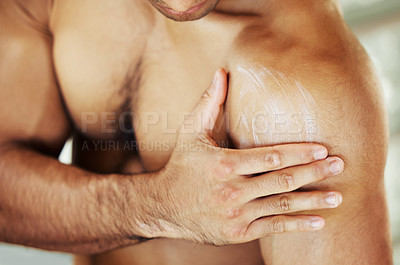 Buy stock photo Closeup shot of a man applying moisturiser to her skin