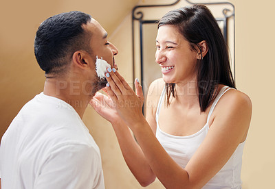 Buy stock photo Shot of a woman putting shaving cream on her boyfriend's face