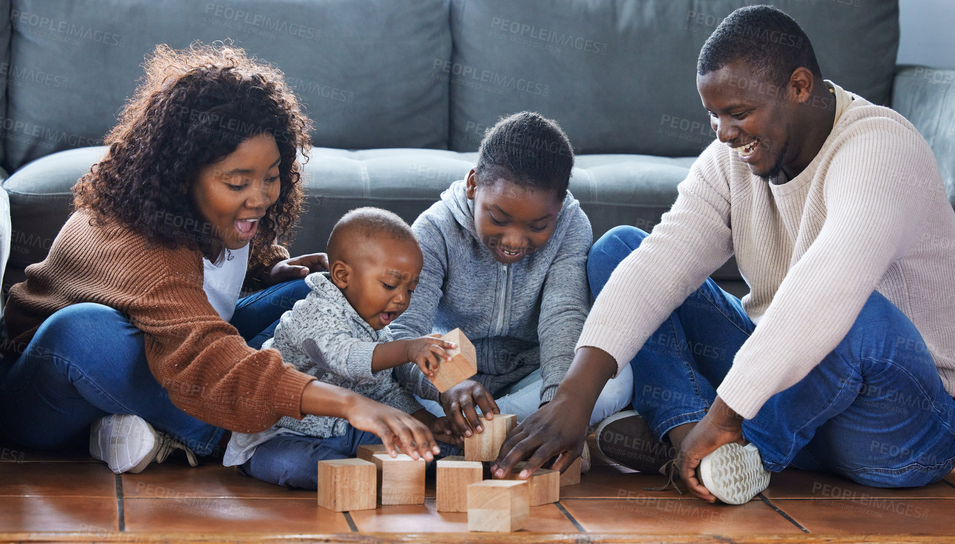 Buy stock photo Shot of a family playing together in the lounge at home