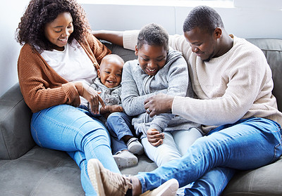 Buy stock photo Shot of a family playing together on the couch in the lounge at home