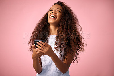 Buy stock photo Happy woman, laughing and funny joke with phone in social media, communication or chat on a pink studio background. Female person with smile in laughter for meme, humor or comedy on mobile smartphone