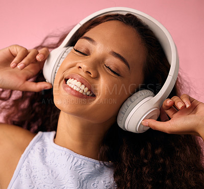 Buy stock photo Girl, relax and listening to music with headphones for jazz or beats on a pink studio background. Happy female person enjoying podcast, audio streaming or sound with smile for radio, song or playlist