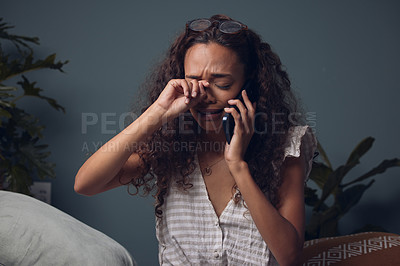 Buy stock photo Shot of a woman crying while talking on her cellphone
