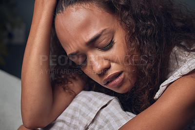 Buy stock photo Sad, girl and depressed with headache in home for burnout or grief with anxiety and unhappy. Woman, alone and crying on sofa in house for heartbreak or breakup, lonely and mental health or emotional.