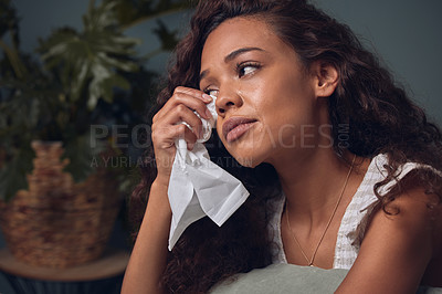 Buy stock photo Crying, woman and depressed with tissue in home for grief or sadness with memory and unhappy. Black girl, alone and tears for sorrow in house for heartbreak or breakup, lonely and mental health.