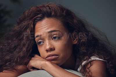 Buy stock photo Sad, girl and depressed with thoughts in home of memory or grief with tears of sorrow and unhappy. Woman, emotional and thinking on sofa in house for heartbreak or breakup, lonely and mental health.
