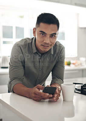 Buy stock photo Portrait, kitchen and man online with smartphone for trending updates or popular topics on social media or internet. Person, home and texting for messaging or connectivity, streaming and download.