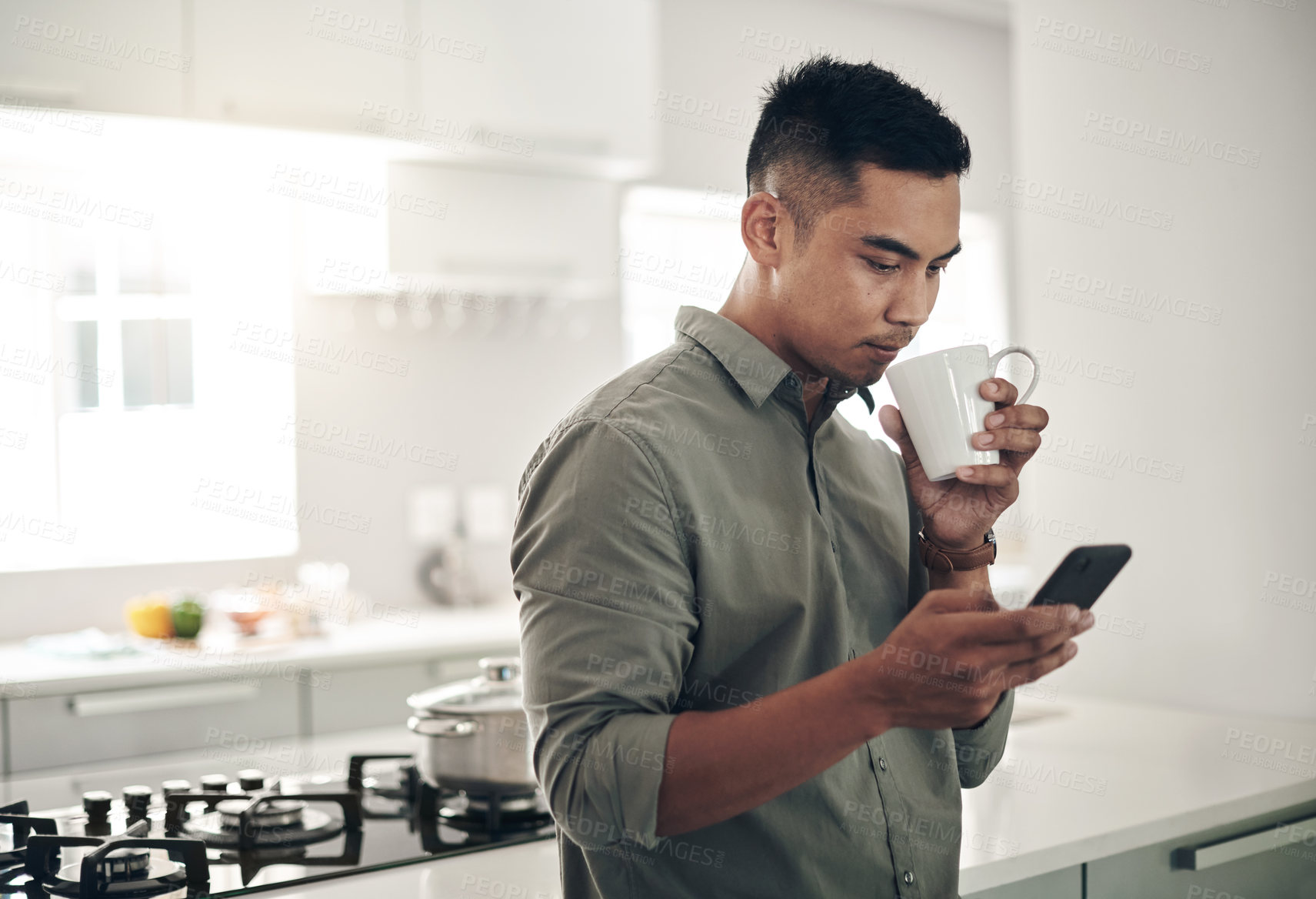 Buy stock photo Man, drink and coffee in kitchen with smartphone for trending updates or popular topics on social media or internet. Person, home and texting for messaging or connection, streaming and download.