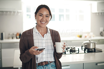 Buy stock photo Portrait, Asian woman or coffee to relax, phone or browse on social media, website or app in kitchen. Gen z girl, smile or smartphone to drink, tea or update of post to connect at weekend of leisure