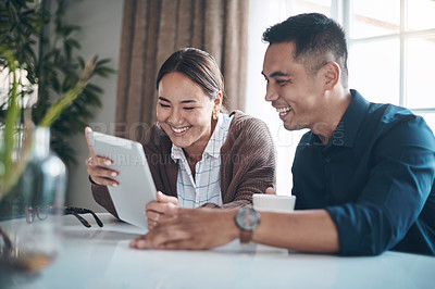 Buy stock photo Tablet, smile and Asian couple networking in home on internet, social media or app with funny meme. Happy, laughing and young man and woman watching video on digital technology at house together.