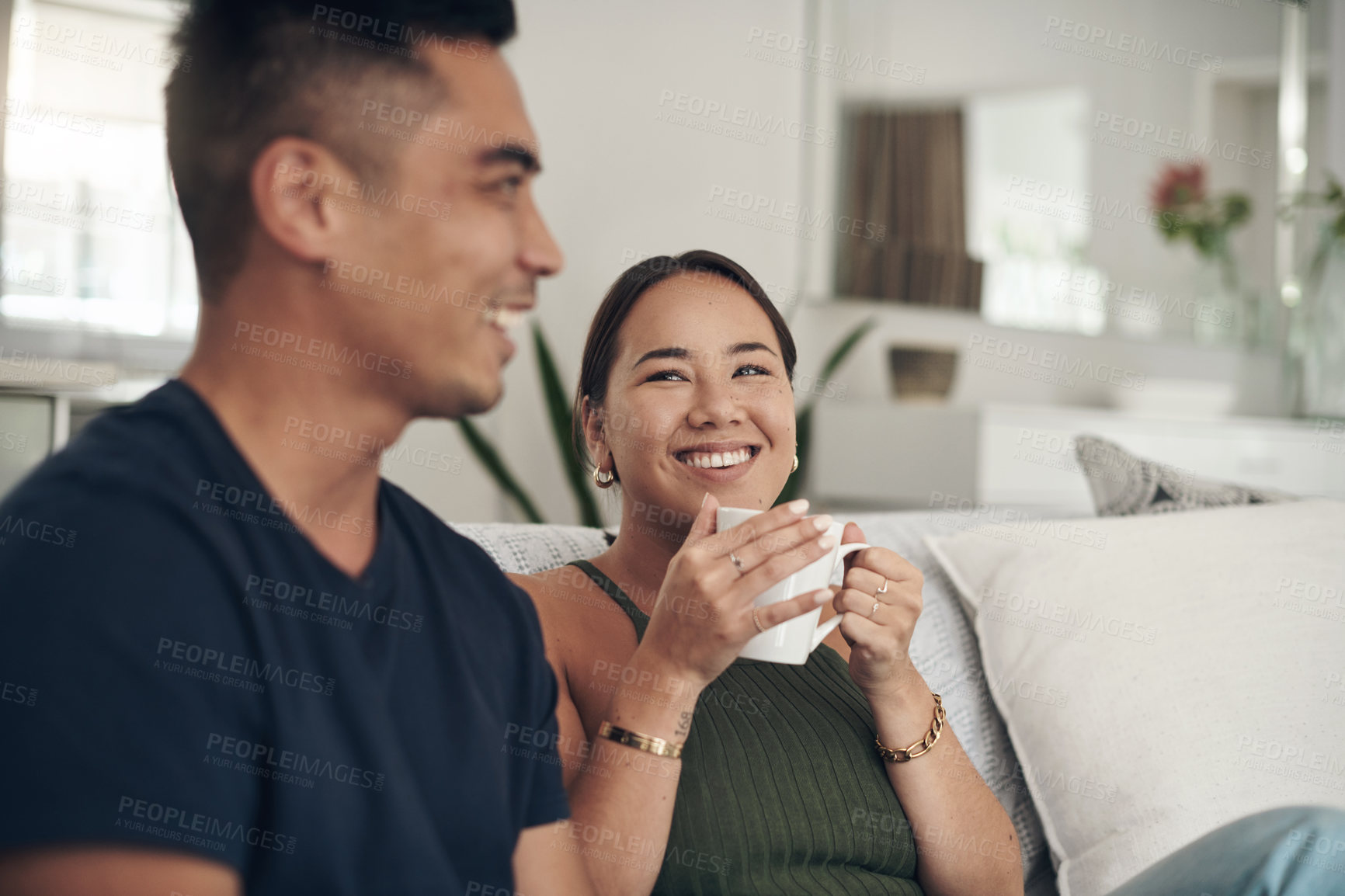 Buy stock photo Relax, smile and couple on sofa with coffee, bonding and happy relationship together in home on weekend. Morning drink, man and woman on couch with tea laughing, talking and love in calm apartment.